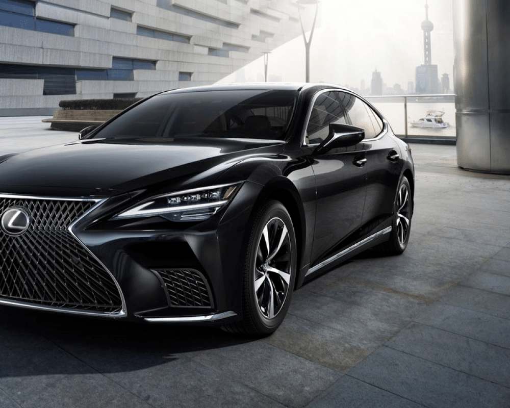Black Lexus luxury sedan parked in an urban setting, representing certified collision repair services by db Orlando Collision, emphasizing quality and safety in autobody repairs.